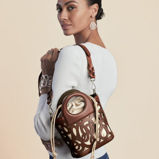 Model wearing Brighton Skribbel French Wire Earrings in silver with matching bracelet and bag.