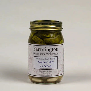 Farmington Sliced Dill Pickles in clear glass mason jar with garlic and dill seeds