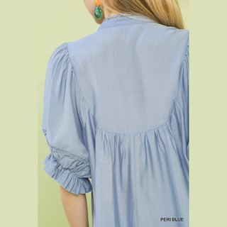 Light blue dress with ruffled sleeves on a person