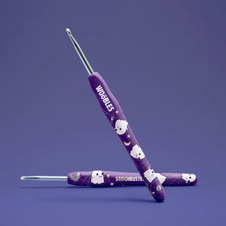 Two purple Woobles Stitchbuster crochet hooks with Halloween ghost and spiderweb design