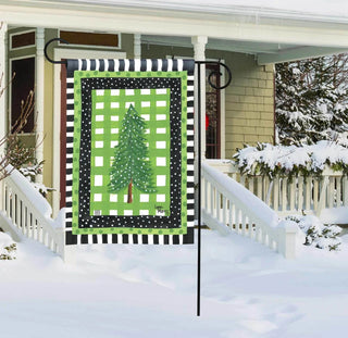 Demdaco Snowy Pines garden flag displayed on stake in snowy front yard setting