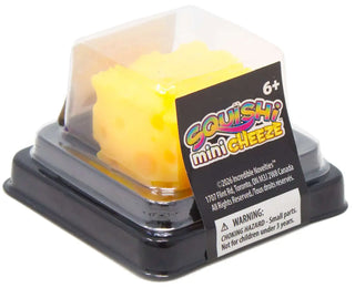 Squishi Mini Cheeze squishy toy in yellow cheese block shape shown in clear packaging with black tray