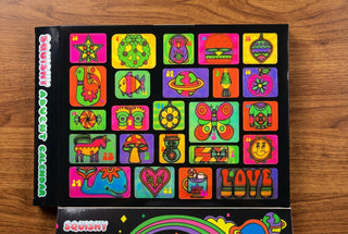 Squishy Advent Calendar with 24 colorful neon panels featuring unicorn, butterfly, owl, and more