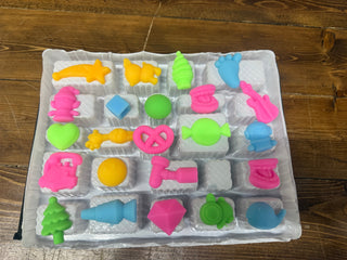 Squishy advent calendar tray with 20 colorful mini novelty erasers in pink, green, blue, and orange