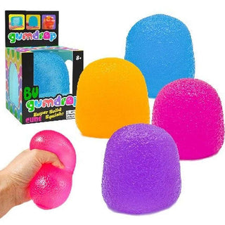 Colorful gumdrop-shaped stress balls with a hand holding one, and a Gumdrop brand box in the background.