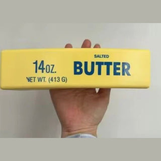Yellow salted butter stick squishy toy with blue text on smooth PU foam