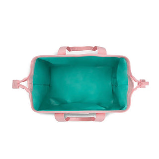 Top-down view of empty Swig cooler interior showing vibrant teal insulation and reinforced pink fabric loops