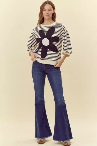 Cream black striped knit sweater with large daisy flower graphic, three-quarter sleeves