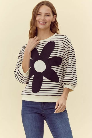 Cream and black striped knit top with large black daisy flower patch graphic