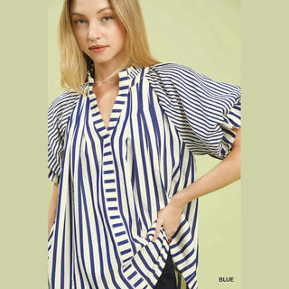 Woman wearing a blue and white striped shirt 