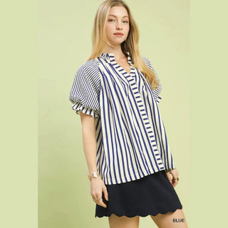Woman wearing a blue and white striped blouse