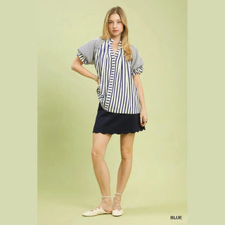 Woman wearing a striped shirt and black skirt 