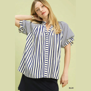 Woman wearing a blue and white striped shirt against 