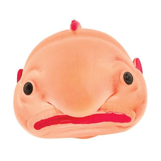 Plush toy resembling a fish with a sad expression 