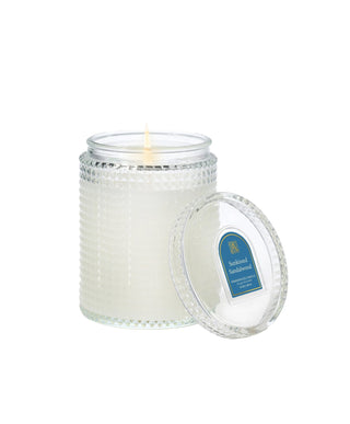 Aromatique Sunkissed Sandalwood fragranced candle in textured glass jar with lid, 15oz
