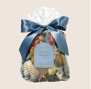 Aromatique Sunkissed Sandalwood decorative fragrance potpourri in clear bag with blue satin bow