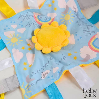 Top-down view of light blue minky lovey with raised yellow sun and ribbon tags