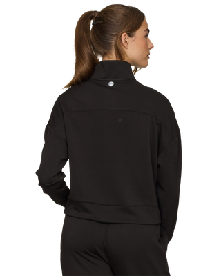 Back view of woman wearing Flag and Anthem Super Soft 1/4 Zip pullover in black with ponytail