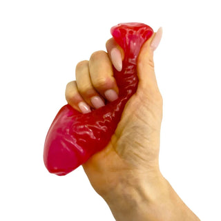 Hand squeezing a red Swedish Fish-shaped squishy stress relief toy