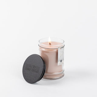 Bridgewater Sweet Grace small jar candle in blush pink with black wooden lid, lit flame visible
