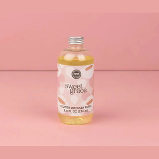 Sweet Grace flower diffuser refill bottle with pink floral label containing pale yellow liquid
