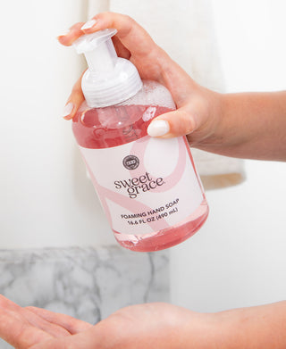 Hand pumping Sweet Grace foaming hand soap by Bridgewater Candle Company, 16.6 fl oz