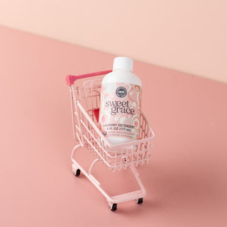 Sweet Grace laundry detergent 6 fl oz bottle displayed in a miniature pink shopping cart