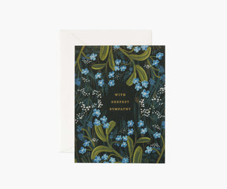 Rifle Paper Co. sympathy card with blue forget-me-not flowers on dark background with envelope