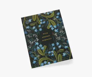 Rifle Paper Co. sympathy card with blue forget-me-not flowers on dark background reading With Deepest Sympathy