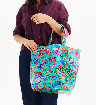 Model holding Consuela Grab N Go Basic tote bag in vibrant Tasha multicolor print