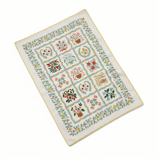 Helena Tea Towel shown at angle displaying folk art botanical pattern and scalloped edge