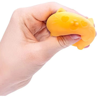 bright yellow squishy cat with heart cheeks mid-compression for stress relief