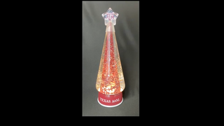 Illuminated Texas A&M conical water globe with glowing amber light and logo base
