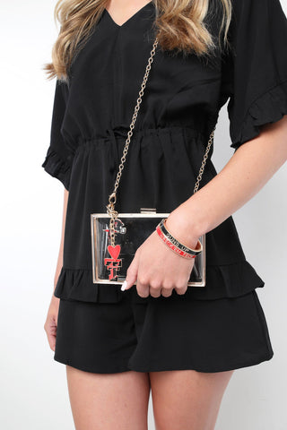 Texas Tech Red Raiders heart cluster bag charm displayed on clear gold-framed crossbody clutch purse