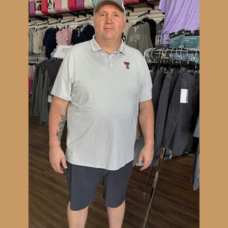 Men wearing light gray white striped Texas Tech polo in retail store setting