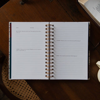 Open spiral-bound Abide Study Journal with lined pages and Bible study prompts