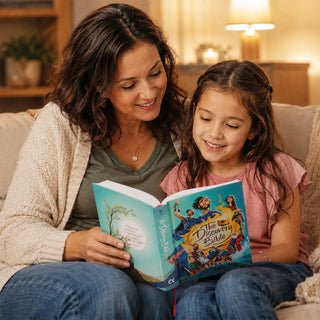Mother and daughter reading The Discovery Bible hardcover together on a cozy couch.