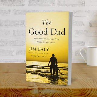The Good Dad paperback book by Jim Daly standing upright on wooden surface
