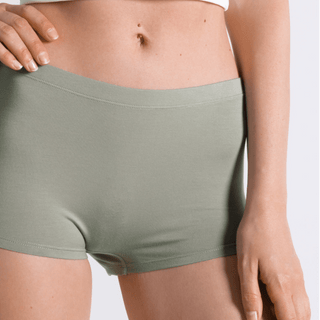 Model wearing Shinesty Manzanilla olive green modal boyshort underwear with belly button piercing visible