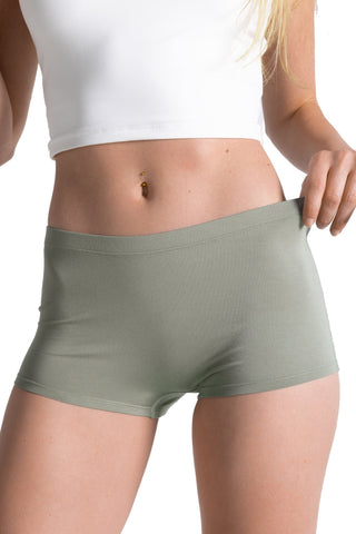 Model wearing olive green modal boyshort underwear with white crop top, showing fitted waistband.