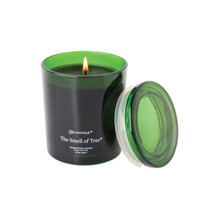 Aromatique The Smell of Tree 10oz green glass candle with lid, lit flame