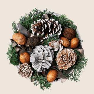 Aromatique The Smell Of Tree decorative fragrance bowl with frosted pinecones, nuts, and evergreen sprigs