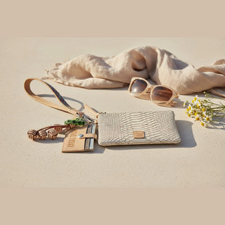Beige wristlet with snake skin pattern, colorful strap, and keychain