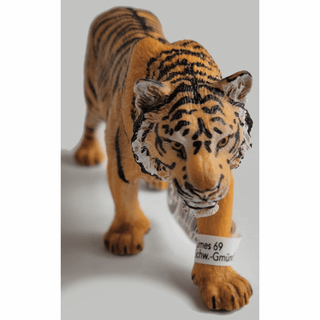 Schleich tiger figurine close-up amber eyes predatory stance and detailed facial stripes