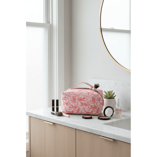 Tiger Jumbo Cosmetic Bag on bathroom counter with makeup and beauty items