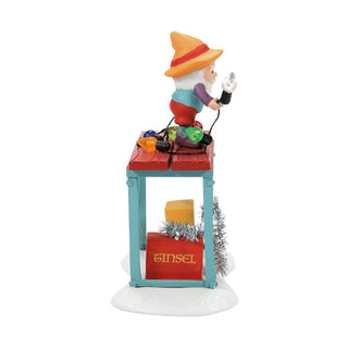 Department 56 Time to Decorate figurine showing elf decorating with ornaments on blue table