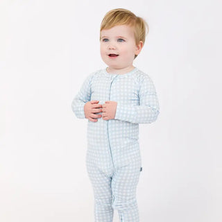 Child wearing a light blue gingham zippie