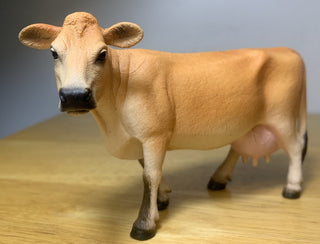 Model of a cow on a wooden surface 