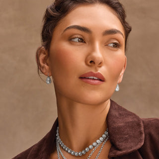 Model wearing Brighton Twinkle Luxe silver crystal drop earrings and layered necklace set