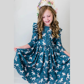 Full body shot of girl twirling in teal unicorn wish dress with voluminous gathered skirt and floral headband